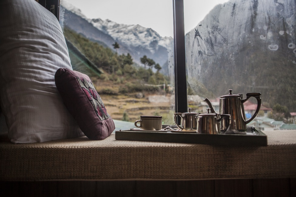 sunroom with hot drink and mountain view